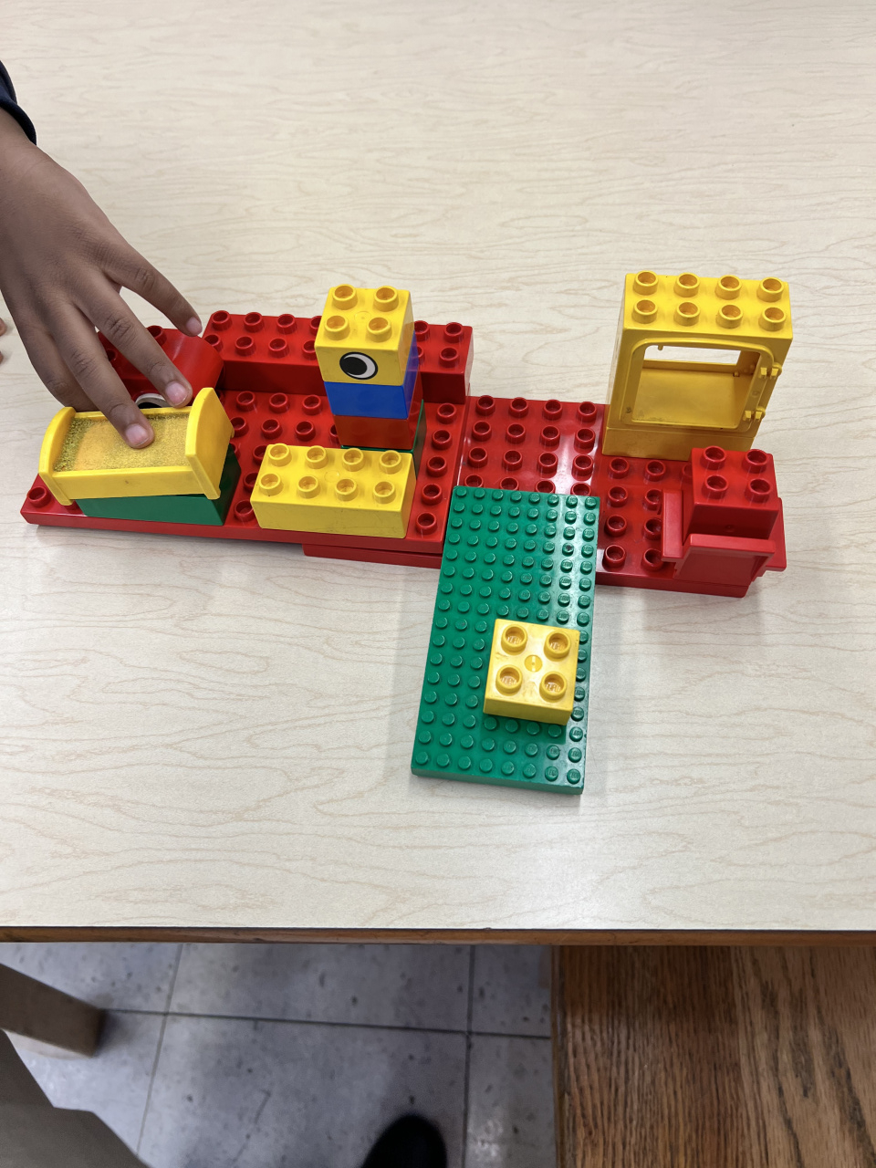 Students using their imagination using legos block and dinosaurs!